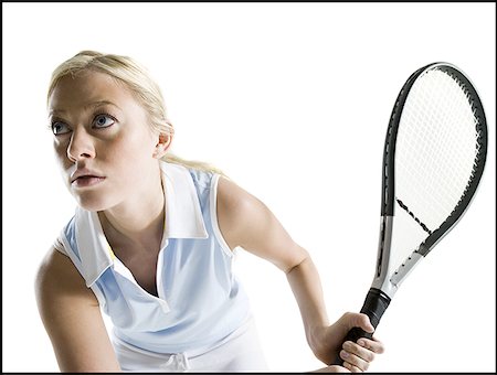 Close-up of a young woman holding a tennis racket Stock Photo - Premium Royalty-Free, Code: 640-01360918