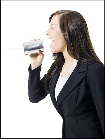 Profile of a teenage girl holding a tin can phone and shouting Stock Photo - Premium Royalty-Free, Code: 640-01360985