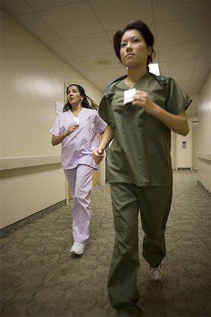 Two female nurses running Stock Photo - Premium Royalty-Free, Code: 640-01361075