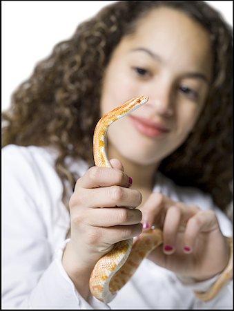 people holding snakes - Close-up of a girl holding a snake Stock Photo - Premium Royalty-Free, Code: 640-01361165