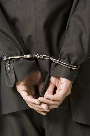 slavery - Rear view of a businessman in handcuffs Stock Photo - Premium Royalty-Free, Code: 640-01361167