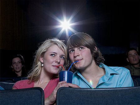 Boy and girl sharing beverage at movie theater Stock Photo - Premium Royalty-Free, Code: 640-01361318