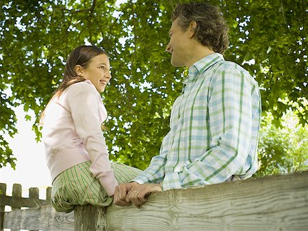 simsearch:6113-07242957,k - Low angle view of a man and his daughter smiling Stock Photo - Premium Royalty-Free, Code: 640-01361386