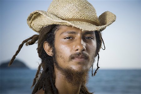 dreadlocks on african americans - Portrait of a young man wearing a straw hat Stock Photo - Premium Royalty-Free, Code: 640-01361636
