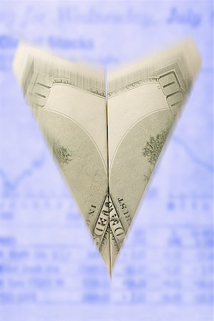 Close-up of a paper airplane made from a one hundred dollar bill Stock Photo - Premium Royalty-Free, Code: 640-01361863