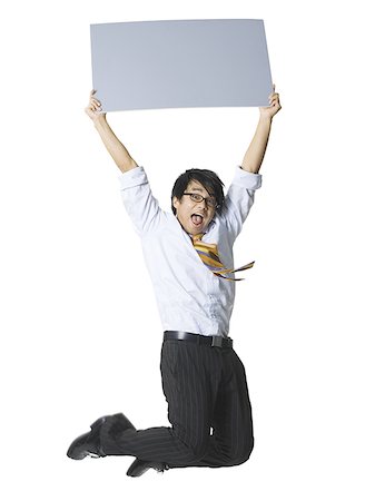 Portrait of a businessman holding a blank sign and jumping Stock Photo - Premium Royalty-Free, Code: 640-01362201