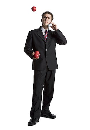 simsearch:640-03260747,k - Businessman juggling while talking on phone Stock Photo - Premium Royalty-Free, Code: 640-01362302