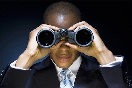 Man looking through binoculars Stock Photo - Premium Royalty-Free, Code: 640-01362357