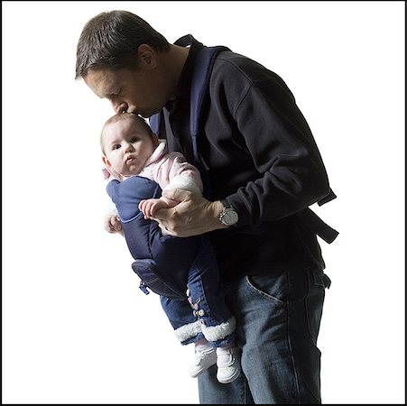 simsearch:640-01354837,k - Close-up of a father kissing his baby daughter on her head Stock Photo - Premium Royalty-Free, Code: 640-01362386