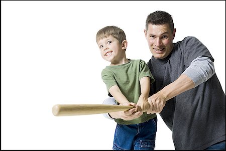 simsearch:640-06050635,k - Portrait of a father teaching his son how to swing a baseball bat Stock Photo - Premium Royalty-Free, Code: 640-01362515