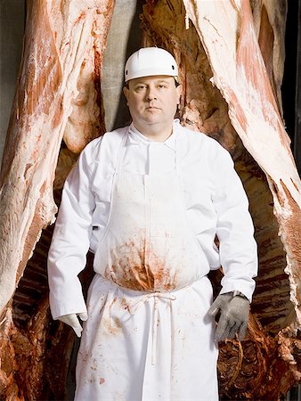 farmyard - Butcher standing with hanging carcass Stock Photo - Premium Royalty-Free, Code: 640-01362554