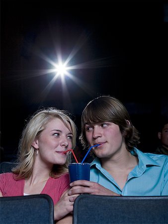 simsearch:640-02773406,k - Boy and girl sharing beverage at movie theater Stock Photo - Premium Royalty-Free, Code: 640-01362810