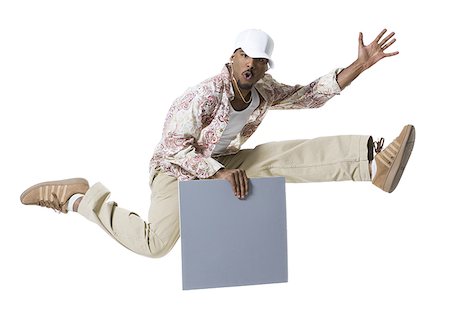 simsearch:640-03265333,k - African American man jumping and holding a blank sign Stock Photo - Premium Royalty-Free, Code: 640-01362850