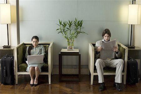 simsearch:640-01362739,k - Young woman sitting in a waiting room using a laptop with a young man reading a newspaper beside her Stock Photo - Premium Royalty-Free, Code: 640-01362873