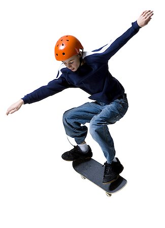 Boy skateboarding with his arms outstretched Stock Photo - Premium Royalty-Free, Code: 640-01362948