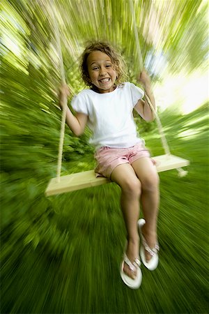 flip flops for kids - Portrait of a girl swinging on a swing Stock Photo - Premium Royalty-Free, Code: 640-01363235