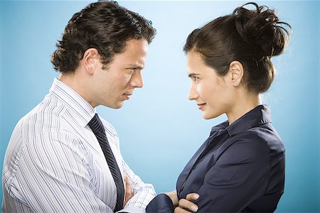 Profile of a young man and a woman looking at each other Stock Photo - Premium Royalty-Free, Code: 640-01363237