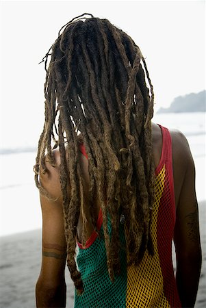 Rear view of a young man on the beach Stock Photo - Premium Royalty-Free, Code: 640-01363328