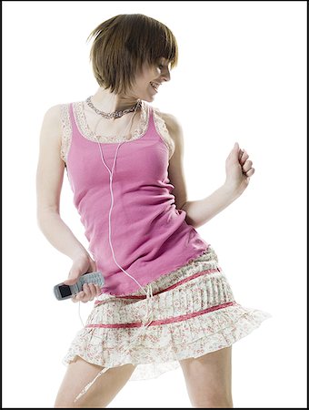 Teenage girl holding a cell phone and listening to music Stock Photo - Premium Royalty-Free, Code: 640-01363538