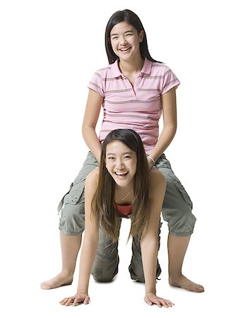 simsearch:400-04847852,k - Portrait of a teenage girl sitting on her sister's back Stock Photo - Premium Royalty-Free, Code: 640-01363549