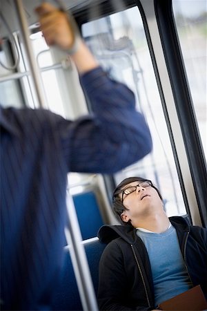 Young man sleeping in a subway train Stock Photo - Premium Royalty-Free, Code: 640-01363586