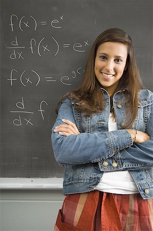school symbol - Female student leaning against chalkboard Stock Photo - Premium Royalty-Free, Code: 640-01363751