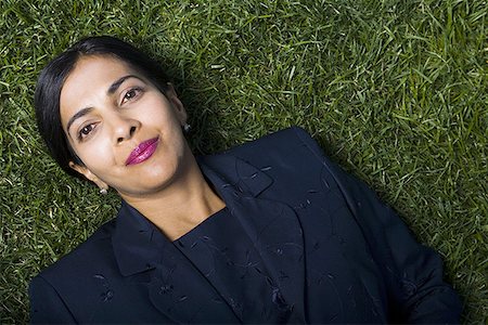 Portrait of a businesswoman lying on a lawn Stock Photo - Premium Royalty-Free, Code: 640-01363855
