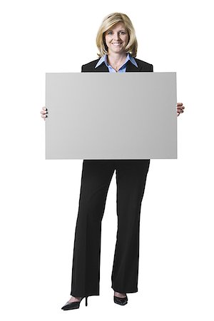 Portrait of a businesswoman holding a blank sign Stock Photo - Premium Royalty-Free, Code: 640-01363879