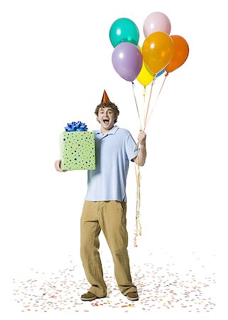 simsearch:673-03826592,k - Man with party hat holding balloons and gift box Stock Photo - Premium Royalty-Free, Code: 640-01458502