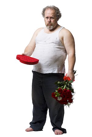 fat man cutout - Disheveled man with red roses and heart box frowning Stock Photo - Premium Royalty-Free, Code: 640-01458709