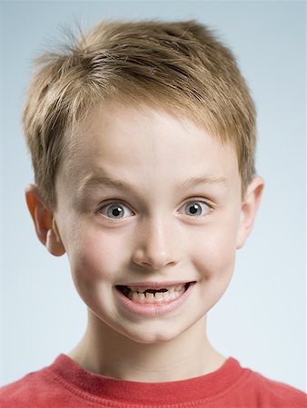 Close-up of boy smiling with missing front teeth Stock Photo - Premium Royalty-Free, Code: 640-01458733