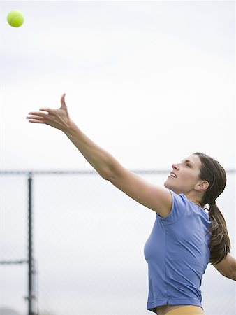 simsearch:640-06050635,k - Woman tossing tennis ball in air to serve Stock Photo - Premium Royalty-Free, Code: 640-01458821