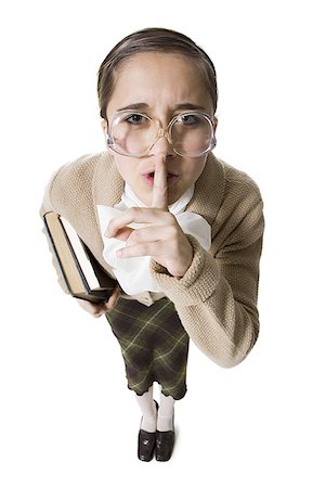 shhh - Female librarian with eyeglasses and books hushing Stock Photo - Premium Royalty-Free, Code: 640-01458848