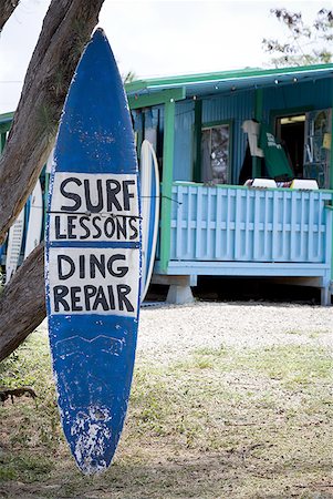 surfboard close up - Surfboard outdoors with Surf Lessons and Ding Repair sign Stock Photo - Premium Royalty-Free, Code: 640-01459028