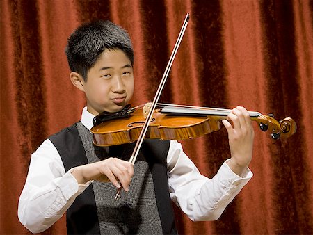 picture of young boy holding violin - Boy playing violin Stock Photo - Premium Royalty-Free, Code: 640-01574967