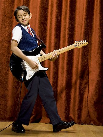 stage play curtain - Boy on stage playing electric guitar Stock Photo - Premium Royalty-Free, Code: 640-01574974