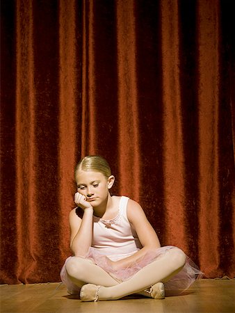 Ballerina girl sitting on stage sulking Stock Photo - Premium Royalty-Free, Code: 640-01575008