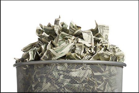 Waste paper basket with crumpled money Stock Photo - Premium Royalty-Free, Code: 640-01575044
