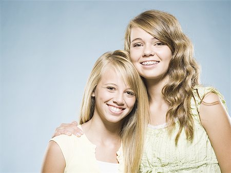 Two girls embracing and smiling Stock Photo - Premium Royalty-Free, Code: 640-01601656