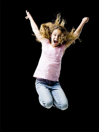 simsearch:640-01601671,k - Girl leaping and smiling with arms up Stock Photo - Premium Royalty-Free, Code: 640-01601676