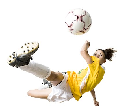 diving (not water) - Teenage girl kicking soccer ball Stock Photo - Premium Royalty-Free, Code: 640-01645314