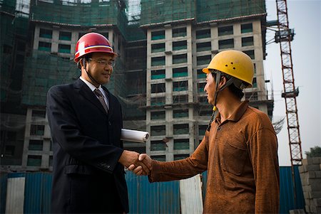 simsearch:640-03262464,k - Construction foreman and worker outdoors shaking hands Stock Photo - Premium Royalty-Free, Code: 640-01645356