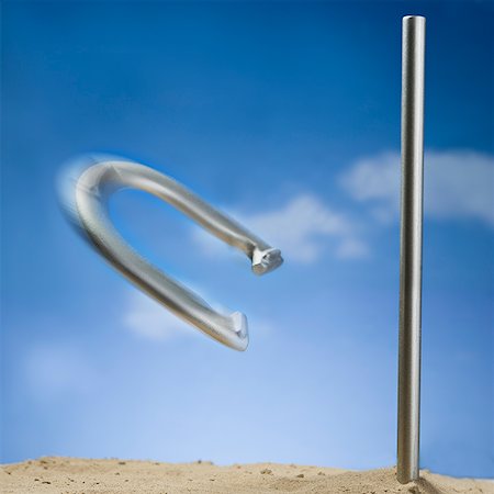 peg - Horseshoe and peg with motion blur and blue sky Stock Photo - Premium Royalty-Free, Code: 640-01645416