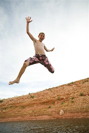 Boy jumping into a lake. Stock Photo - Premium Royalty-Free, Code: 640-02656673