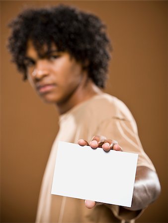 simsearch:640-02776875,k - young man in a brown shirt holding a note card. Stock Photo - Premium Royalty-Free, Code: 640-02656868