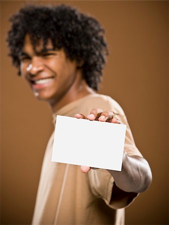 simsearch:640-02776875,k - young man in a brown shirt holding a note card. Stock Photo - Premium Royalty-Free, Code: 640-02656869
