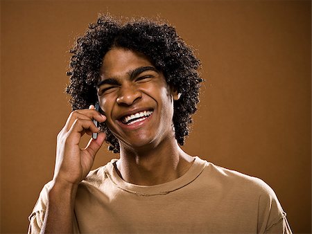 simsearch:640-02776875,k - young man in a brown shirt on a cell phone. Stock Photo - Premium Royalty-Free, Code: 640-02656860