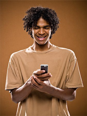 simsearch:640-02776875,k - young man in a brown shirt on a cell phone. Stock Photo - Premium Royalty-Free, Code: 640-02656861