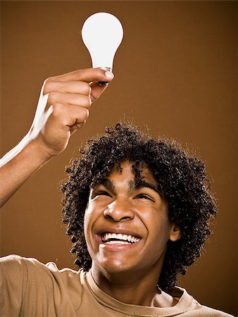 simsearch:640-02776875,k - young man in a brown shirt holding light bulbs. Stock Photo - Premium Royalty-Free, Code: 640-02656875