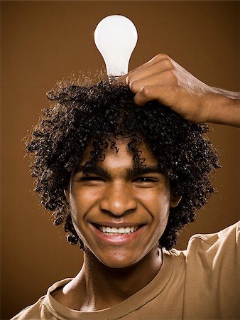 simsearch:640-02776875,k - young man in a brown shirt holding light bulbs. Stock Photo - Premium Royalty-Free, Code: 640-02656876